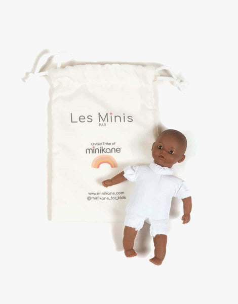 Minikane Mini Light-eyed Pio doll in ecru romper and bonnet
